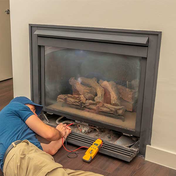 Technician Servicing a Gas Fireplace